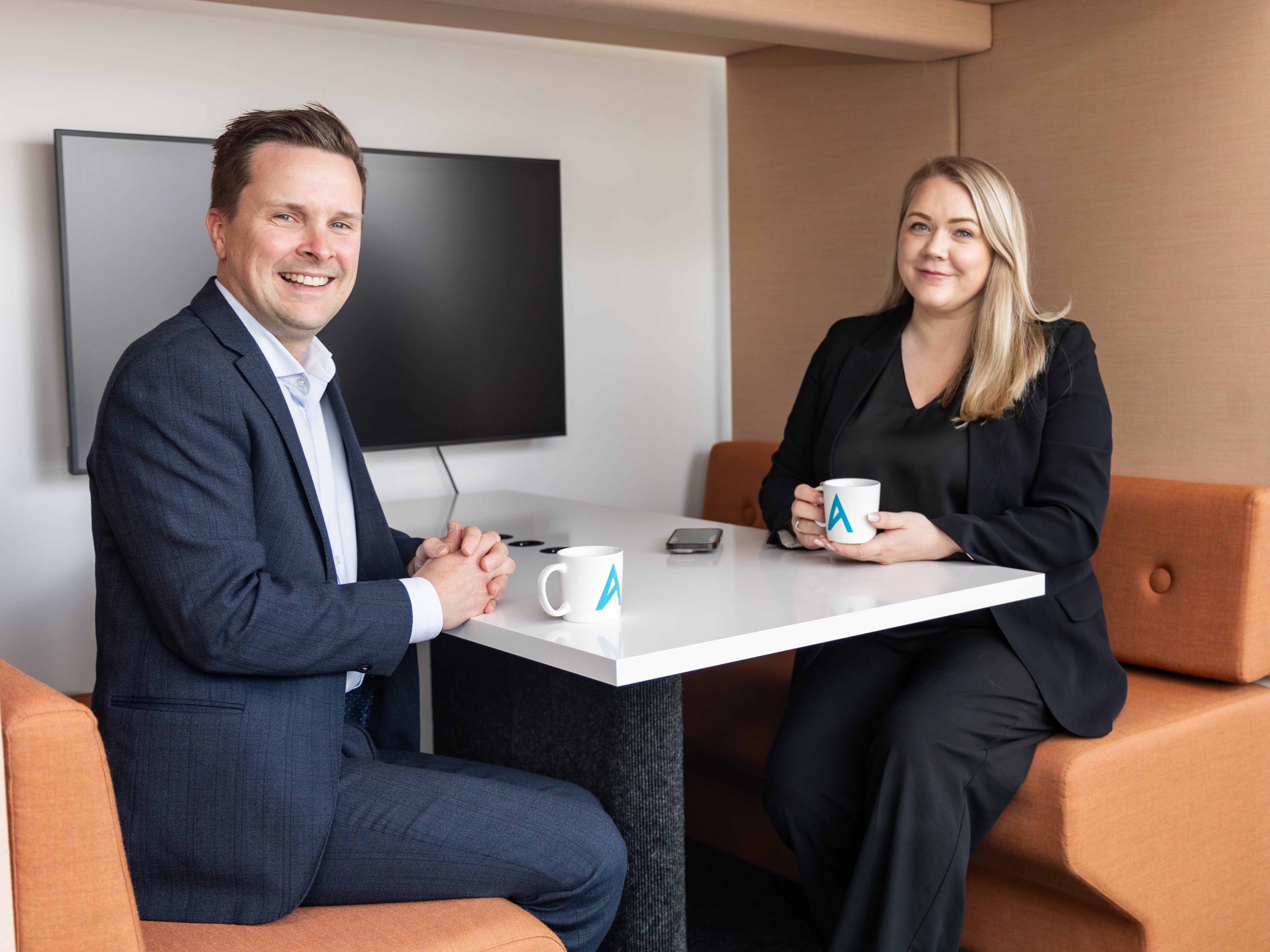 To personer sitter i en bås